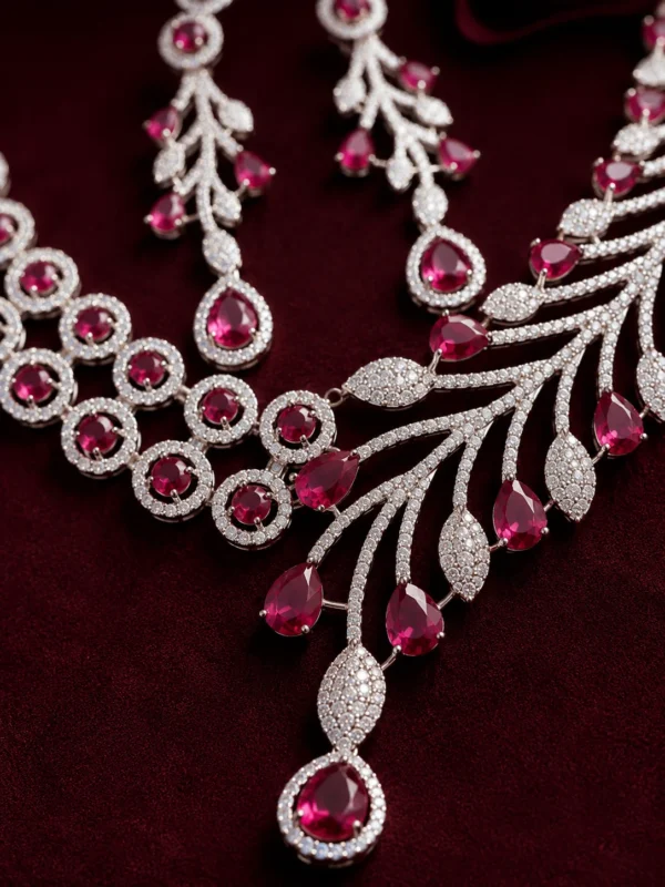 Close-up of crimson teardrop stones and American Diamond detailing on the Crimson Royale necklace set