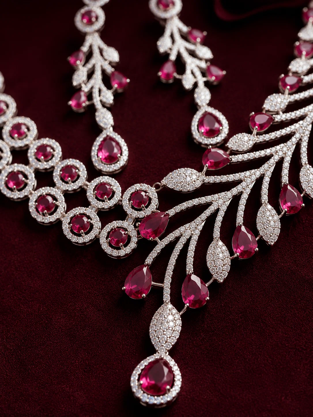 Close-up of crimson teardrop stones and American Diamond detailing on the Crimson Royale necklace set